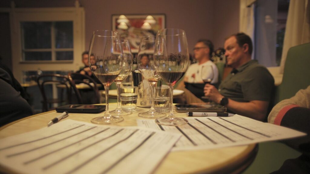 Answer sheets and glasses of wine on a table during a Wine Options League round at Bar Septimus